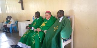 Kitale Catholic Diocese Bishop Maurice Crowley (center)
