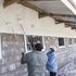 Workers apply paint on a newly built classroom in Elburgon.