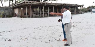 One of the Amani Tiwi Beach hotel managers shows the deserted beachfront of the hotel