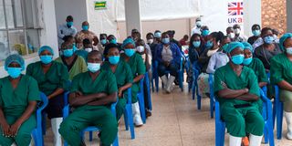 Doctors and nurses, working at an isolation centre attending a brief at the Mubende referral hospital