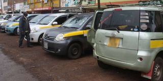 A passenger at a matatu stage in Nyeri which has been taken over by Toyota Sienta vehicles