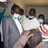 Baringo Governor Benjamin Cheboi (in grey suit) talking to a patient while on an inspection tour of Eldama Ravine hospital