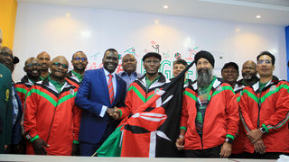 NOC-K President Paul Tergat hads over flag to shooting team