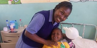 Elizabeth Robai Lukresia, a second year pediatric student nurse at Kenya Medical Training College (KMTC) with a child patient