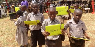 Pupils from Kibirigwi Primary School in Kirinyaga County display tablets