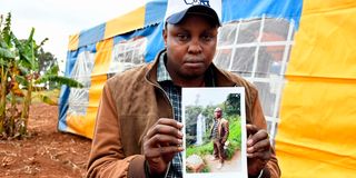 Peter Gakio Karanja holds a photo of his younger brother, John Wanderi