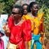 Ugandan women in colourful gomesi dresses.