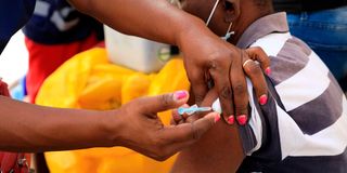 A medic administers a Covid-19 vaccine at Majengo Dispensary in Mombasa County in July. 