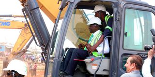 President William Ruto operates an excavator machine as he launched the Soweto East Zone B social housing programme in Kibera.