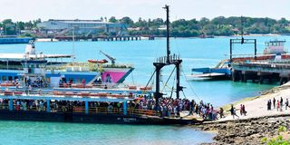 Passengers board MV Harambee as MV Safari arrives at the Likoni crossing