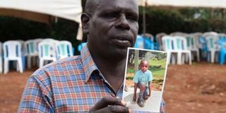 Mr Gilbert Kirwa Maina with a photo of his son,