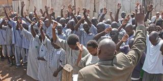 A religious leader conducts a service for inmates at Kodiaga prison in Kisumu County