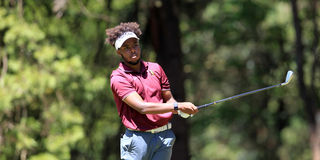 Njoroge Kibugu of Muthaiga Golf Club follows the progress of his tee shot 