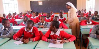A teacher takes Grade Seven learners through their studies at Tetu Girls Junior Secondary School in Nyeri County 