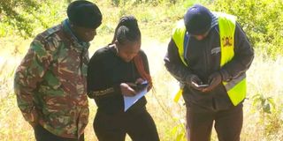 Investigators at the scene where the body of Mr Charles Moko was found in Kari village, Murang'a County