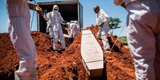 Municipal Johannesburg Morgue workers bury the coffin of an unidentified body