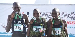 Charles Lokir (centre) poses with other medalists