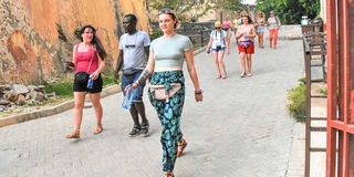 Tourists walk down a lane at Fort Jesus in Mombasa’s Old Town