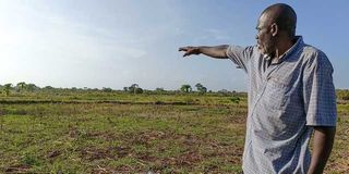 Mr Feruz Mohammed, a rice farmer in Vanga, points at empty paddy fields in the village last month.