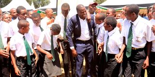 Kiharu MP Ndindi Nyoro shares a laugh with a group of students from Mugoiri Day Secondary School 