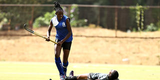 Grace Bwire (down) of Strathmore University Scorpions in action against Alice Owiti  of Lakers