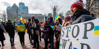A person holds a sign calling to stop the war during a Stand with Ukraine rally at Copley Square in Boston, Massachusetts