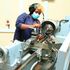 A mechanical engineering student operates a lathe machine at Nyeri National Polytechnic