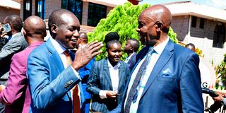 Education Cabinet Secretary Ezekiel Machogu (right) confers with Kisii County Governor Simba Arati