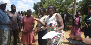 Patroba Jelagat talks to police about the boundary in dispute at Kipkorgot area in Ainabkoi Sub County