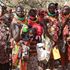 Locals wait for their rations of relief food distribution by President William Ruto