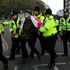 A demonstrator is temporarily detained by police during an anti-immigration protest march in Dover