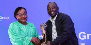 Laikipia Governor Joshua Irungu (right) presents trophy to Purity Githui