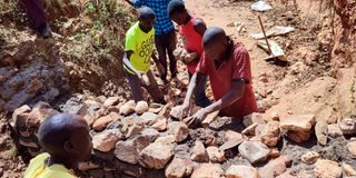 Community members construct a sand dam in Senatwo, West Pokot County.