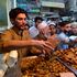 Muslim devotees crowd to buy food in a market on the first day of the holy fasting month of Ramadan in Peshawar