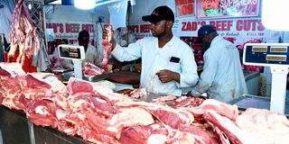 An attendant at Zad’s Butchery and Meat Suppliers stocks up fresh meat at Burma Market in Nairobi