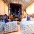 Workers load cartons of counterfeit Lato milk