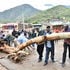 West Pokot Deputy Governor Robert Komolle assists in moving a log that blocked Kitale -Lodwar highway after raging floods 