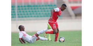 Ulinzi Stars defender Njoroge Wilfred (left) vies for the ball with Kenya Police midfielder Clifton Miheso 