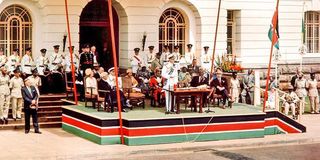 Prince Philip of Great Britain speaks while Prime Minister Jomo Kenyatta (right) listens 