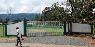 A man walks past the main entrance to Bomet Green Stadium