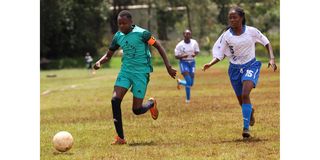 Thika Queens forward Chris Kach (left) vies with Zetech Sparks defender Zipporah Magige