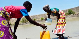 Women fetch water at an almost dried-up water pan at Bora Imani in Magarini, Kilifi County