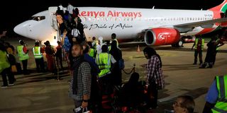 Passengers board an aeroplane for the inaugural direct KQ flight to Dubai from Moi International Airport, Mombasa