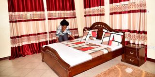 Airbnb Vacation Rentals owner Corazon Chepkemboi prepares a bed for guests at the facility that is located on Beach Road