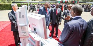 Former President Uhuru Kenyatta and his then deputy William Ruto inspect medical equipment