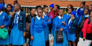 Secondary school students wait to board matatus at Afya Centre in Nairobi on May 9.