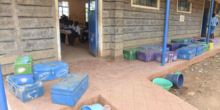 Learning going on at Kapindasum Primary Schools in Baringo South, with learners' metal boxes outside