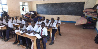 A lesson going on, with and mattresses inside a classroom at Kapindasum Primary School in Baringo South Constituency