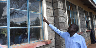 Kapindasum Primary School headteacher Elijah Kipton shows Nation.Africa a window with bullet holes on May 11, 2023