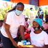 Save the Teenage Girl Initiative Founder Peris Wangari (left) presents gift hampers to girls 